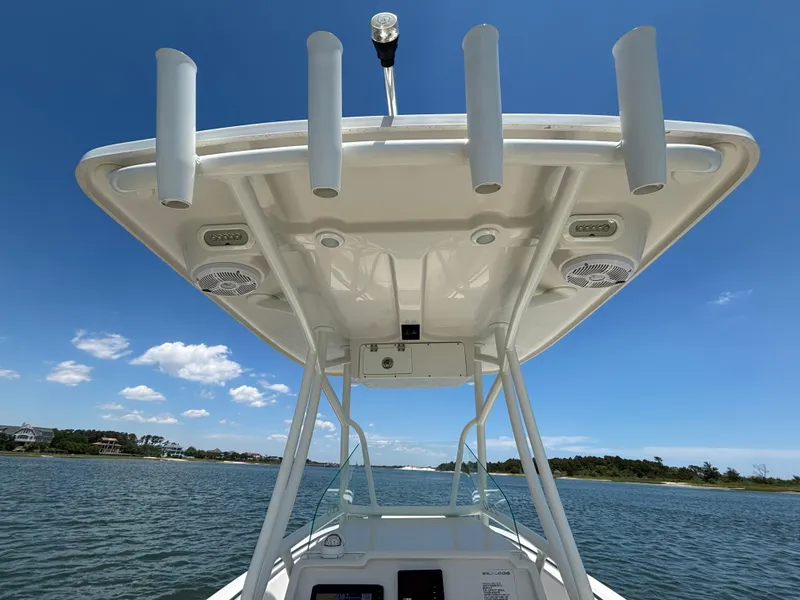 Slide: The Image of 2020 Sailfish 220 CC boat with T-top and rod holders on a sunny day. - 26