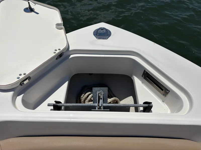 Slide: The Image of Anchor storage compartment on 2020 Sailfish 220 CC boat, open lid, rope visible. - 8