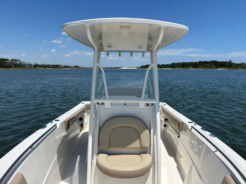 Slide: The Image of 2020 Sailfish 220 CC boat on calm water under clear blue sky. - 9
