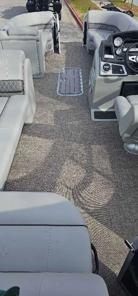 Slide: The Image of 2023 Ranger Reata 223C boat interior with gray seating and control panel. - 3