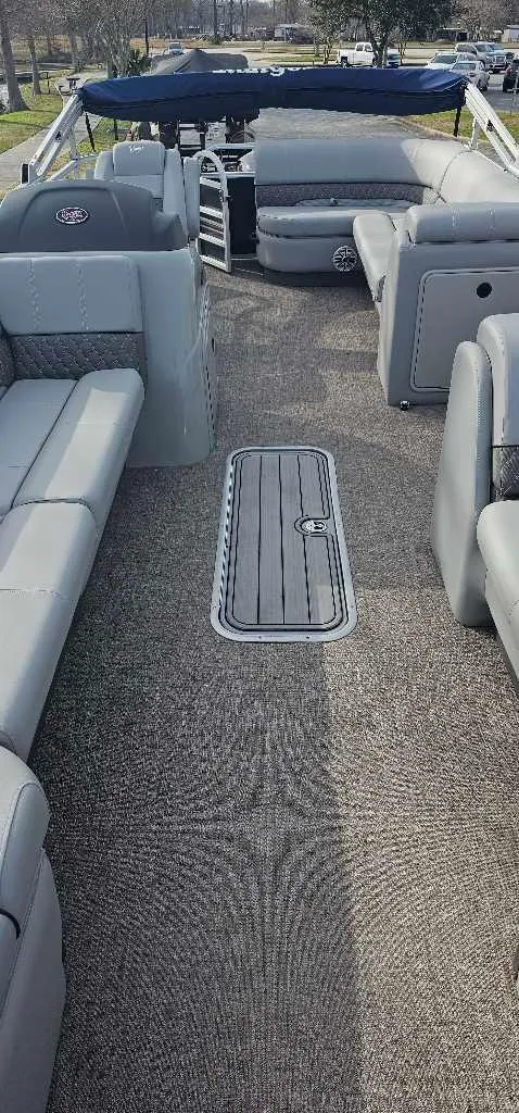 Slide: The Image of 2023 Ranger Reata 223C boat interior with gray seating and carpeted floor. - 4