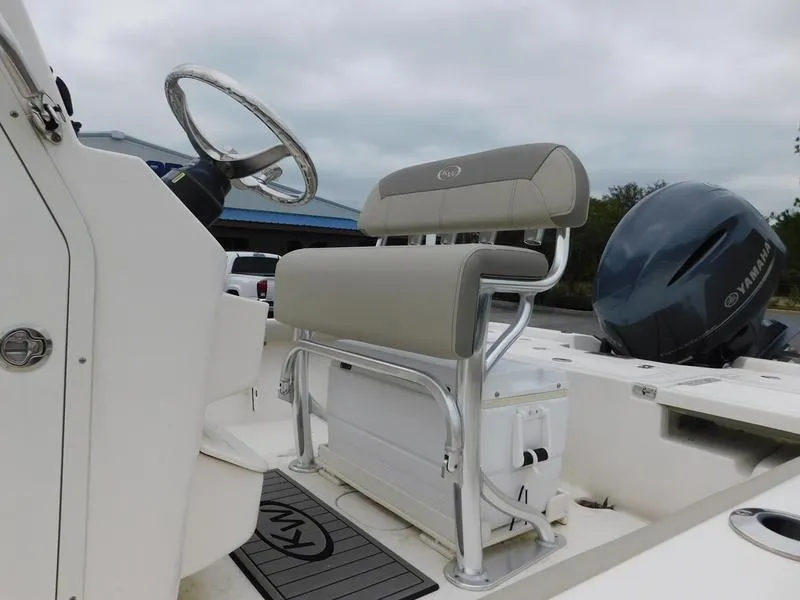 Slide: The Image of 2023 Key West 210BR boat interior with steering wheel and seating. - 9