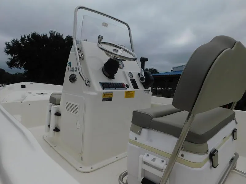 Slide: The Image of 2023 Key West 1720CC center console boat interior with steering wheel and seating. - 11