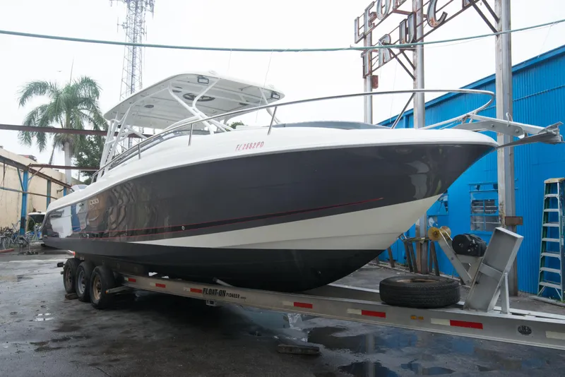 Slide: The Image of 2006 Hydra-Sports Vector 3300 VX boat on a trailer in a marina. - 13
