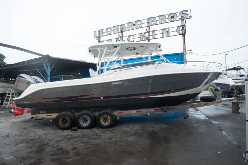 Slide: The Image of 2006 Hydra-Sports Vector 3300 VX boat on a trailer at a marina. - 14