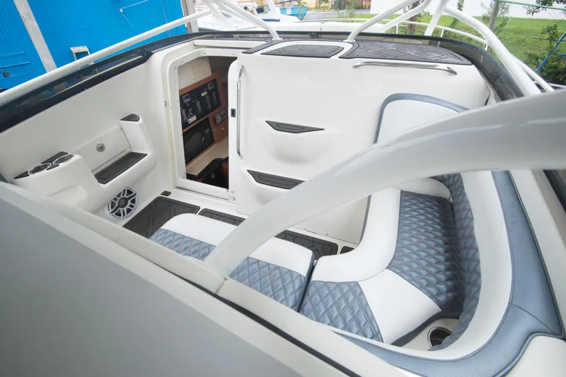 Slide: The Image of 2006 Hydra-Sports Vector 3300 VX interior, featuring white and blue seating and modern controls. - 17