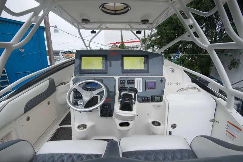 Slide: The Image of 2006 Hydra-Sports Vector 3300 VX boat cockpit with dual navigation screens and steering wheel. - 19