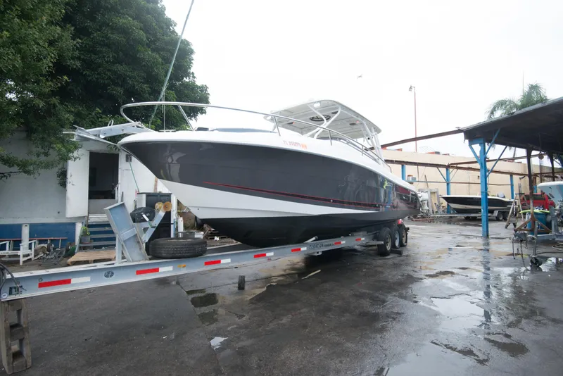 Slide: The Image of 2006 Hydra-Sports Vector 3300 VX boat on a trailer in a marina. - 2