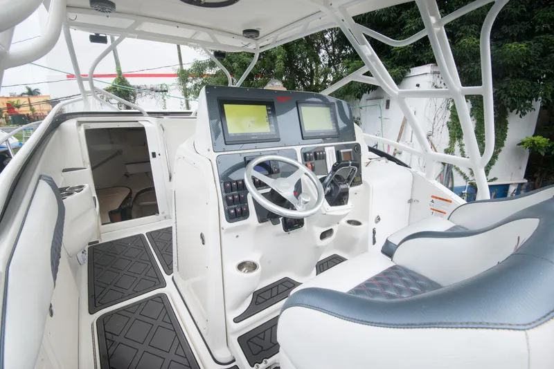 Slide: The Image of 2006 Hydra-Sports Vector 3300 VX boat cockpit with dual screens and cushioned seating. - 20