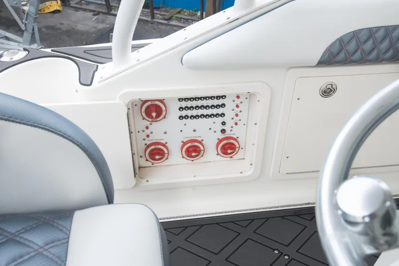 Slide: The Image of 2006 Hydra-Sports Vector 3300 VX control panel with red knobs and switches. - 25