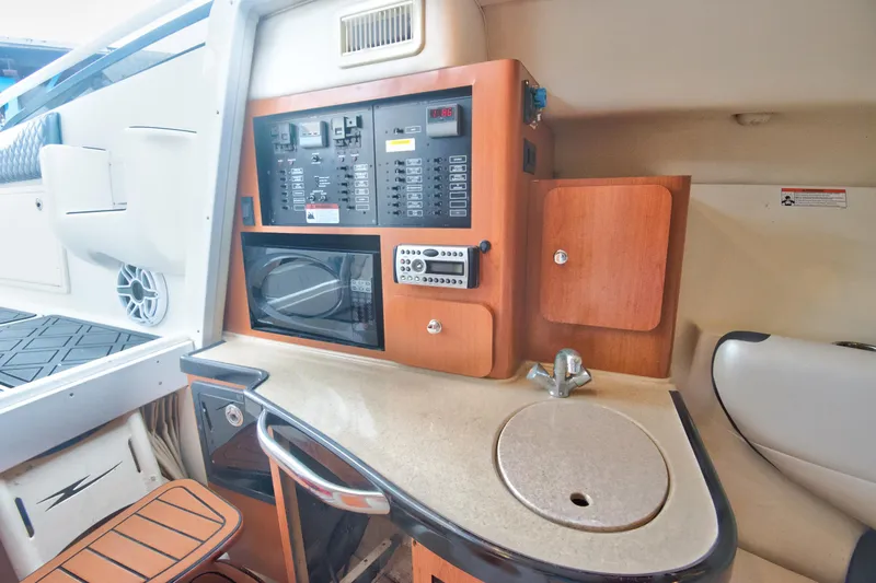 Slide: The Image of 2006 Hydra-Sports Vector 3300 VX cabin interior with kitchenette and control panel. - 30