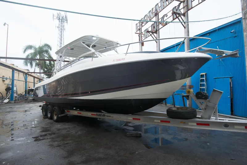 Slide: The Image of 2006 Hydra-Sports Vector 3300 VX boat on a trailer in a marina. - 4