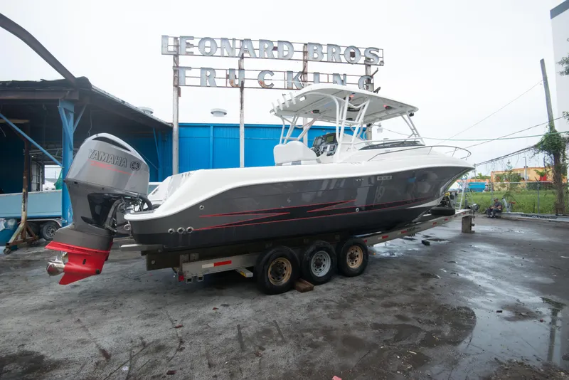 Slide: The Image of 2006 Hydra-Sports Vector 3300 VX boat on a trailer at a dockyard. - 6
