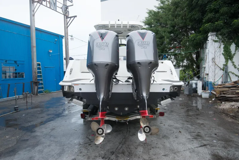 Slide: The Image of 2006 Hydra-Sports Vector 3300 VX with twin outboard engines in a boatyard. - 8
