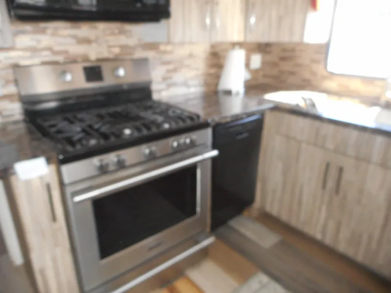 Slide: The Image of Modern kitchen in 2000 Stardust Cruisers houseboat with stainless steel appliances and wood cabinetry. - 11