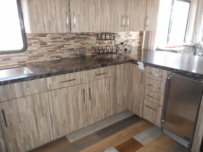 Slide: The Image of Modern kitchen in 2000 Stardust Cruisers Pure Enchantment Share #27 with wood cabinets and stone countertop. - 13