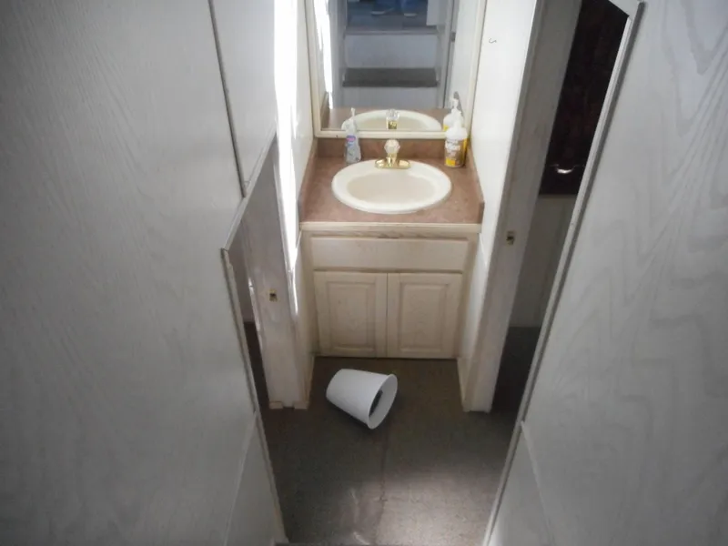 Slide: The Image of Small bathroom with sink and mirror in Stardust Cruisers Pure Enchantment Share #27, 2000 model. - 17