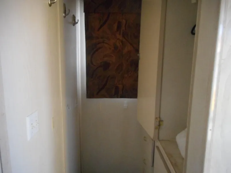 Slide: The Image of Narrow hallway with hooks and cabinets in a 2000 Stardust Cruisers Pure Enchantment Share #27. - 22