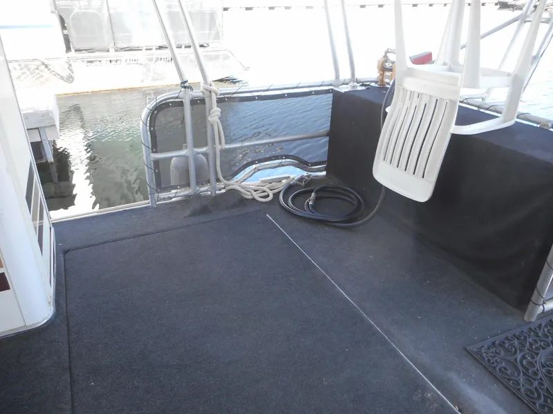 Slide: The Image of Houseboat deck area with seating, ropes, and water view. Stardust Cruisers Pure Enchantment 2000. - 25