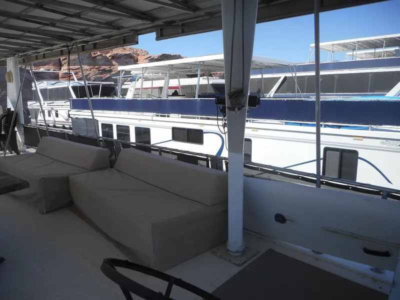 Slide: The Image of Houseboat deck with beige seating, overlooking docked boats, clear sky. Stardust Cruisers Pure Enchantment 2000. - 28