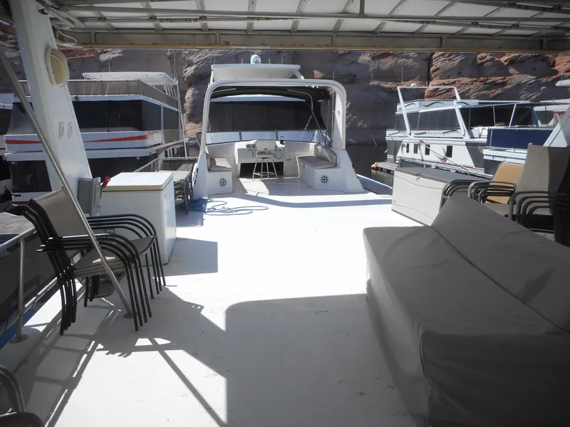 Slide: The Image of Houseboat deck with seating, chairs, and neighboring boats, Stardust Cruisers Pure Enchantment 2000 model. - 32