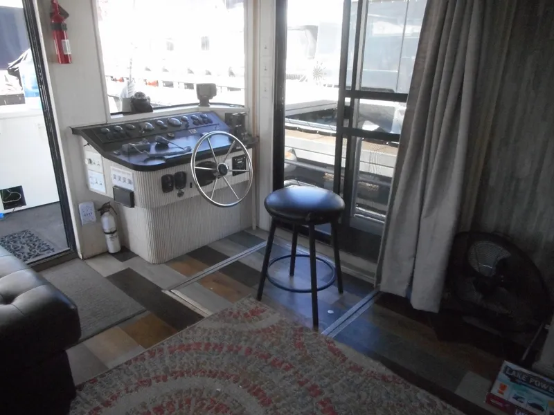 Slide: The Image of Helm area of 2000 Stardust Cruisers Pure Enchantment houseboat with stool and control panel. - 6