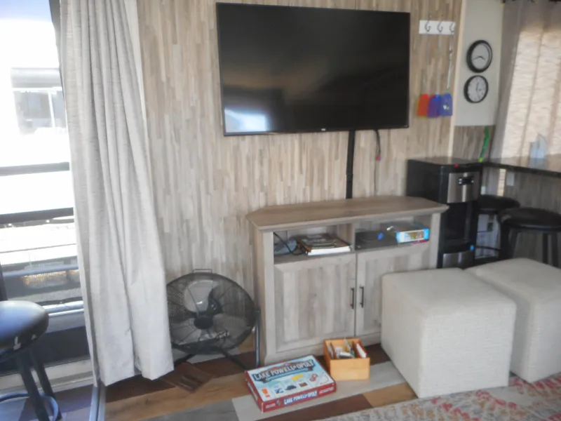 Slide: The Image of Living area with TV, fan, and games on Stardust Cruisers Pure Enchantment Share #27, 2000 model. - 7