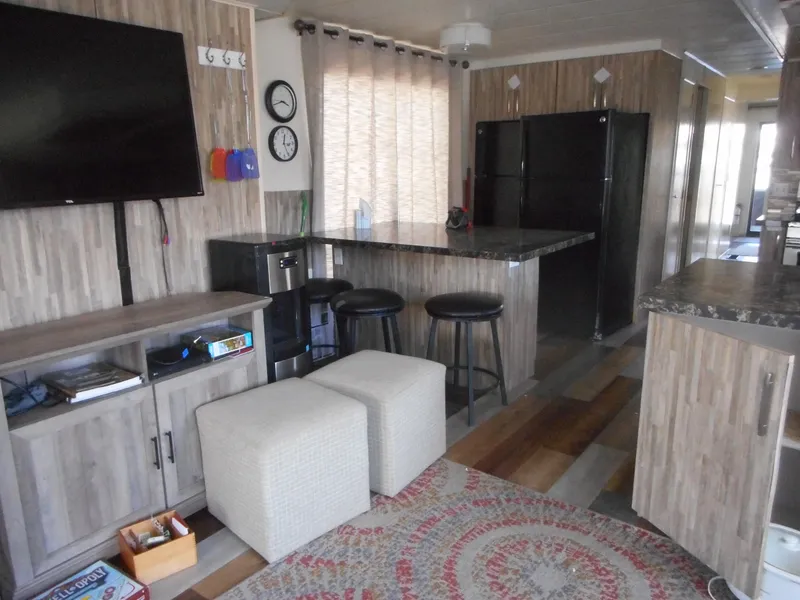 Slide: The Image of Modern houseboat interior with wood accents, bar stools, and a cozy seating area. - 9