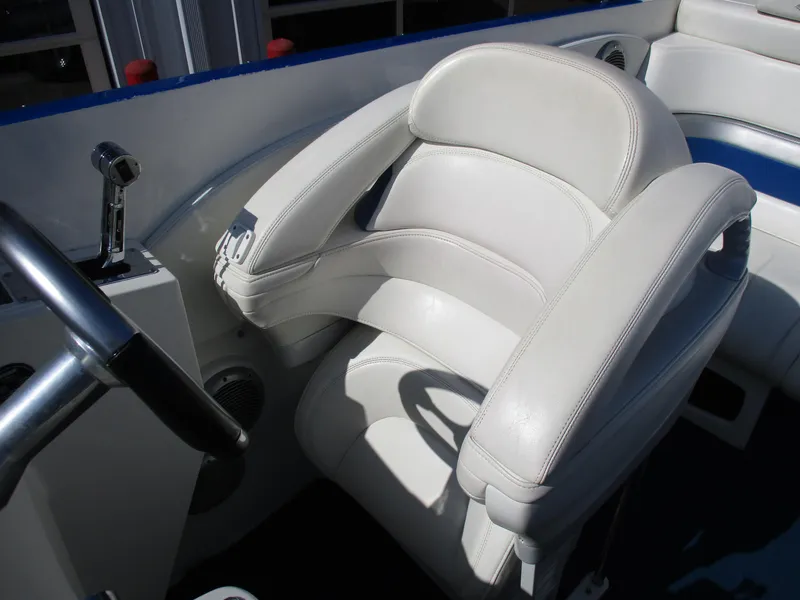 Slide: The Image of 2002 Hustler 388 SLINGSHOT boat interior with white leather captain's chair. - 14