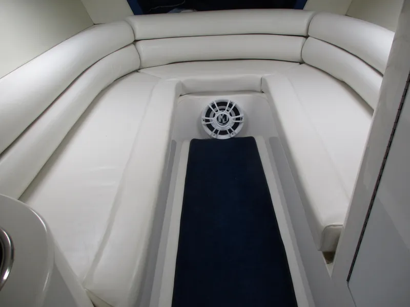 Slide: The Image of 2002 Hustler 388 SLINGSHOT boat interior with white leather seating and blue carpet. - 21