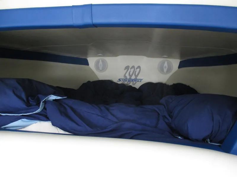 Slide: The Image of Interior cabin of 2002 Hustler 388 SLINGSHOT with blue bedding. - 22