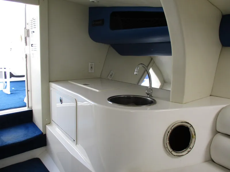Slide: The Image of 2002 Hustler 388 SLINGSHOT boat interior with sink and storage. - 24