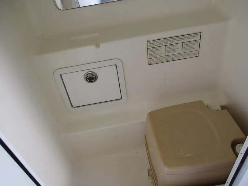 Slide: The Image of 2002 Hustler 388 SLINGSHOT boat interior storage compartment and portable toilet - 25