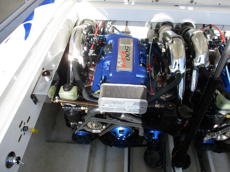Slide: The Image of 2002 Hustler 388 SLINGSHOT engine compartment with high-performance components. - 27