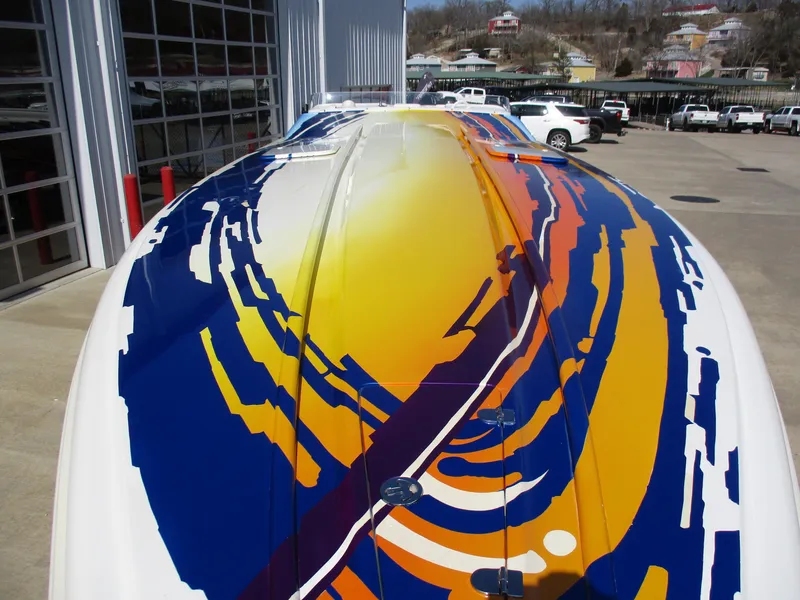 Slide: The Image of 2002 Hustler 388 SLINGSHOT boat with vibrant, colorful hull design. - 3