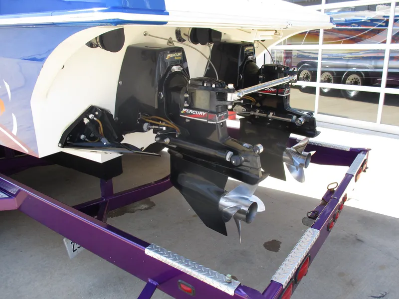 Slide: The Image of 2002 Hustler 388 SLINGSHOT boat with dual Mercury outboard engines on a trailer. - 7