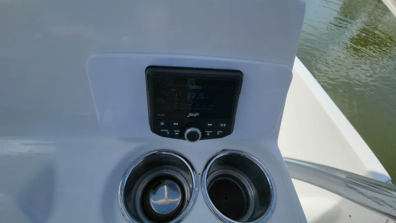 Slide: The Image of NauticStar 2140 Sport 2020 boat console with stereo and cup holders. - 12