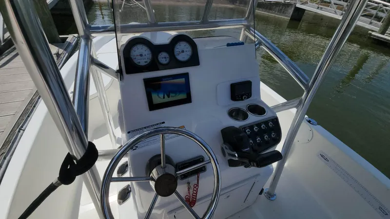 Slide: The Image of 2020 NauticStar 2140 Sport boat console with steering wheel and navigation instruments. - 14
