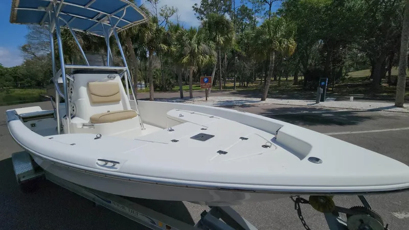 Slide: The Image of 2020 NauticStar 2140 Sport boat on trailer in a park setting. - 25