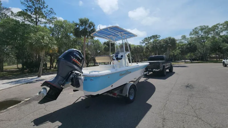 Slide: The Image of 2020 NauticStar 2140 Sport boat on trailer, parked outdoors. - 28