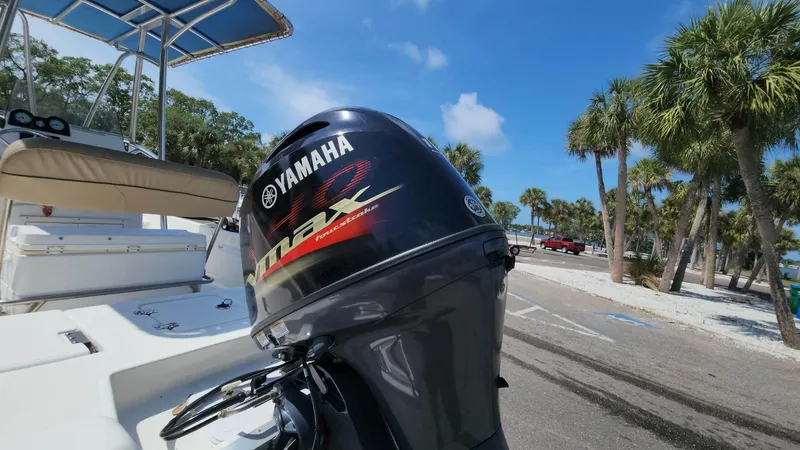 Slide: The Image of 2020 NauticStar 2140 Sport with Yamaha outboard motor at a sunny marina. - 30