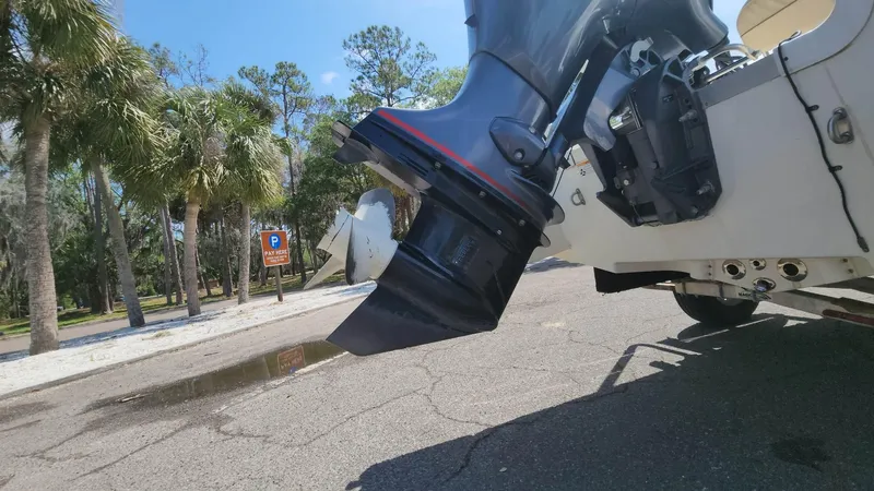 Slide: The Image of NauticStar 2140 Sport 2020 boat engine close-up in a sunny outdoor setting. - 32
