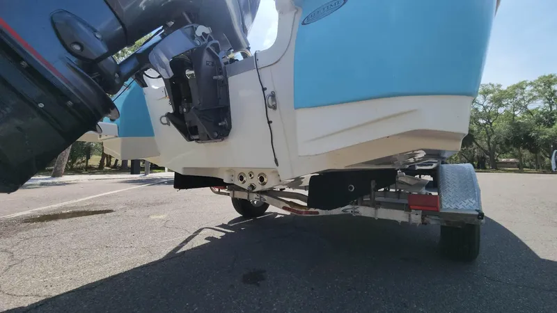 Slide: The Image of 2020 NauticStar 2140 Sport boat on trailer, rear view with outboard motor. - 35