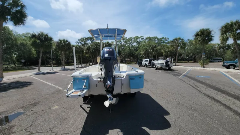 Slide: The Image of 2020 NauticStar 2140 Sport boat in a parking lot with palm trees. - 38