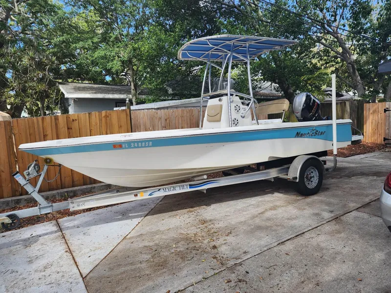 Slide: The Image of 2020 NauticStar 2140 Sport boat on trailer in driveway. - 47