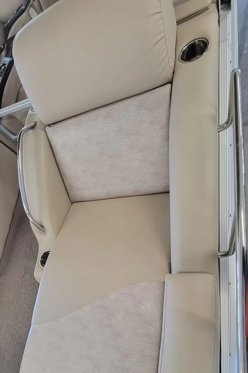 Slide: The Image of 2011 Bennington 2575 RCW 3 I/O boat seat with beige upholstery and cup holder. - 12