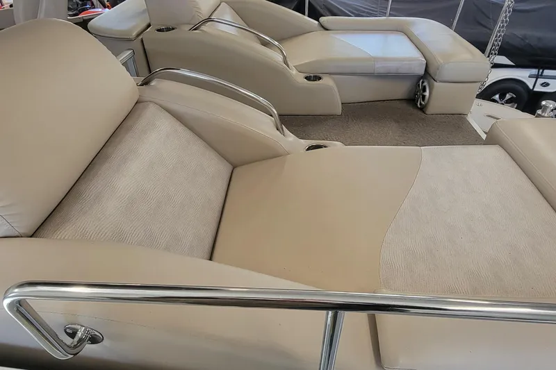 Slide: The Image of Luxurious seating on a 2011 Bennington 2575 RCW 3 I/O boat, featuring beige upholstery. - 13
