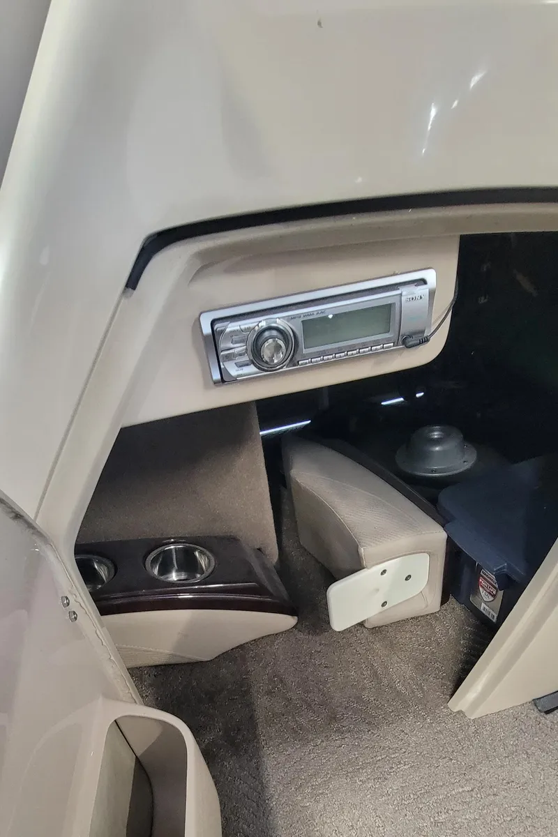 Slide: The Image of 2011 Bennington 2575 RCW 3 I/O boat interior with stereo system and cup holders. - 16