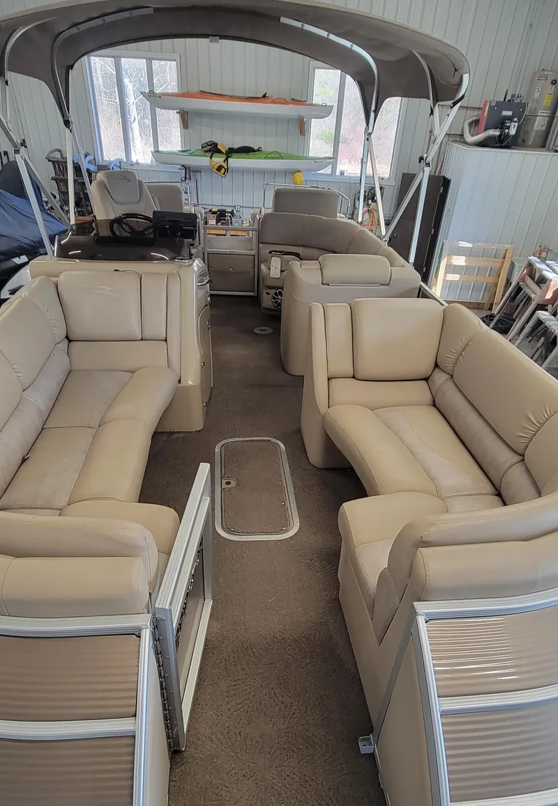 Slide: The Image of 2011 Bennington 2575 RCW 3 I/O pontoon boat with beige interior seating. - 4