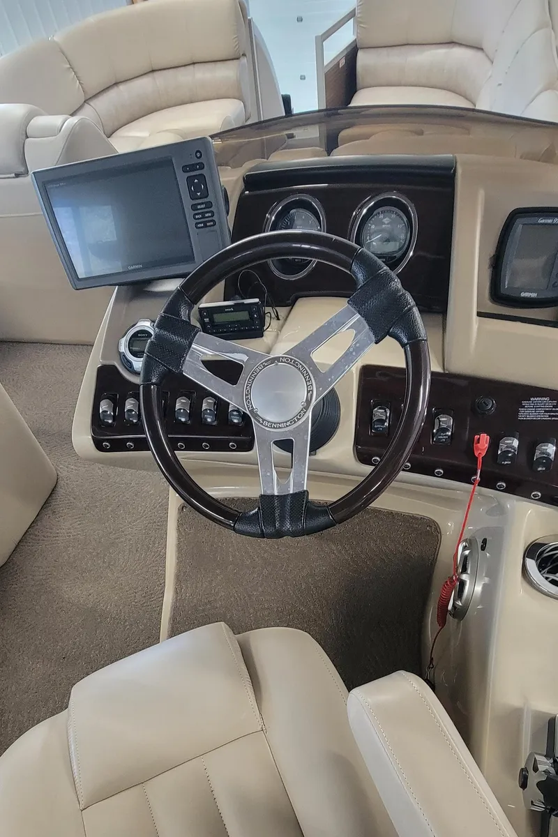 Slide: The Image of 2011 Bennington 2575 RCW 3 I/O boat dashboard with steering wheel and control panel. - 7
